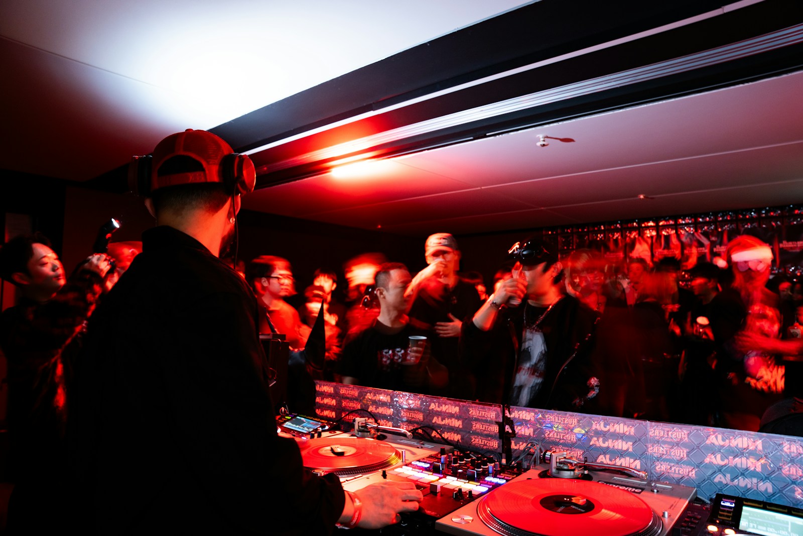 Dj performing for a crowd at a nightclub